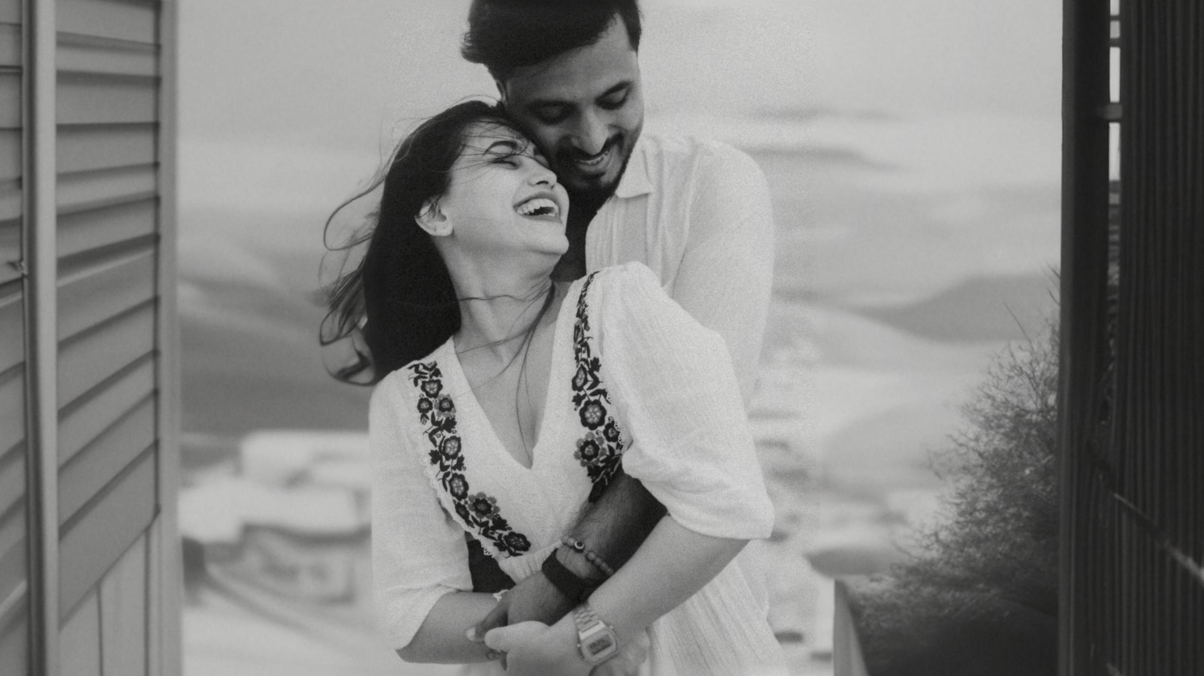 A romantic couple outdoors, embracing each other in a scenic setting